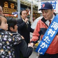Pressing the flesh: Nagoya Mayor Takashi Kawamura shakes hands with supporters in Naka Ward on Sunday as three candidates kicked off their campaigns for mayor.  | KYODO
