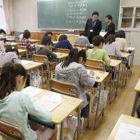 Skills check: Students take the national achievement examination at an elementary school in Tokyo on Wednesday. 
 | KYODO