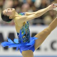 Elegance on ice: Akiko Suzuki performs her free skate on Saturday at the World Team Trophy at Yoyogi National Gymnasium. Suzuki won the event with 199.58 points. | AFP-JIJI