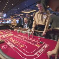 Action: Casino school student Tommie Alexander (left) runs a craps table for the first time at Maryland Live Casino in Hanover, Maryland, on April 5, joined by classmates in the same uniform, Dana Trantham (center) and Darren Rice. | THE WASHINGTON POST