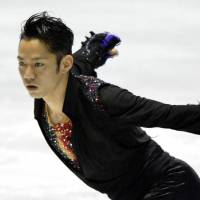 Grabbing the spotlight: Daisuke Takahashi performs in the men\'s free skate on Friday at the World Team Trophy at Yoyogi National Gymnasium. Takahashi finished first with 249.52 points. | KYODO