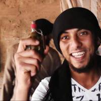 Armed and dangerous: A militant poses with a grenade in the al-Jazeera region on the Iraqi side of the Syria-Iraq border. Fight looms for rival Syria rebel factions