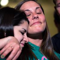 In vain?: Carlee Soto (left), sister of the late Sandy Hook teacher Victoria Soto, and Erica Laffferty, daughter of Sandy Hook Principal Dawn Hochsprung, who was also killed in the November shooting massacre in Connecticut, embrace outside the Senate chamber after a vote Wednesday on firearms legislation. Republican senators, backed by a small band of rural-state Democrats, scuttled the most far reaching gun control legislation in two decades, rejecting calls to tighten background checks on firearms buyers. Stronger U.S. gun law fails to pass in Senate