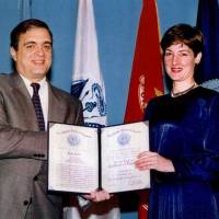 Two faces: In 1997, CIA Director George Tenet awards Ana Montes the Certificate of Distinction, the third-highest national-level intelligence honor. While Montes was excelling at her U.S. government job, she also was spying for Cuba. At right, her FBI booking photo on the day of her arrest, Sept. 21, 2001. A most dangerous spy