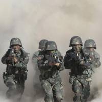 People\'s Liberation Army soldiers carry out a drill in the ethnically restless and strife-torn Xinjiang Uighur Autonomous Region in northwestern China on Monday. | XINHUA NEWS AGENCY/KYODO
