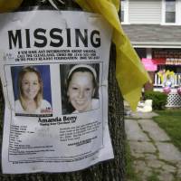 Yellow ribbon: A missing poster still rests on a tree outside the Cleveland home of Amanda Berry after she was found on May 6. Berry and two other women had been held captive in a house nearby for a decade. The advent of the early-warning system Amber Alert now makes it easier to inform the public when a child goes missing. Technology changes odds in abductions