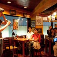 \"An Englishman walks into a bar . . . \": Britons Jay Hoare and John McBride (below) perform standup at The Hobgoblin pub in Shibuya. | NATE JENSEN PHOTOS