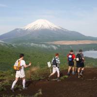 Trekking for a cause: Teams tackle the 100 km Oxfam Trailwalker course from Odawara, Kanagawa Prefecture, to Lake Yamanaka in the shadow of Mount Fuji. Resolve to get involved this new year