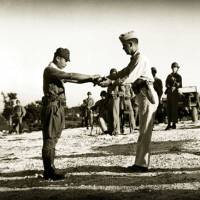 Unbowed: Renegade Capt. Sakae Oba surrenders his sword to a U.S. officer on Dec. 1, 1945. Japan's renegade hero gives Saipan new hope