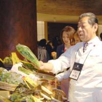 Let\'s get cooking: Chef Yoshihiro Murata of Kikunoi examines vegetables produced in Tohoku during the May 31 event held at a hotel in Tokyo. | MELINDA JOE PHOTOS