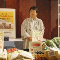 A rice vender from Yamagata exhibits the prefecture\'s farm products. | JANE SINGER