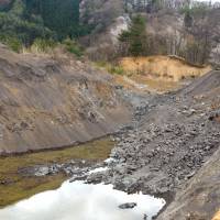 Paying the price: A Nagano Prefecture hill dug away to refill huge holes left by gravel extraction from lowland site. | WINIFRED BIRD