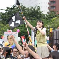 The peace!: Leader of the all-girl group Seifuku Kojo Iinkai sings at an anti-nuclear power demonstration earlier this year. | TAKUMI SUIDU