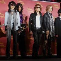 Seeing double: Members of X Japan line up with their wax lookalikes at Madame Tussauds Tokyo on Monday. From left: Pata, Heath, Yoshiki, Toshi and Sugizo. | MIKE SUNDA