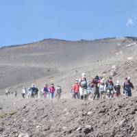 Mountain trek: Climbers descend from the top of Mount Fuji. | ANDREW LEE