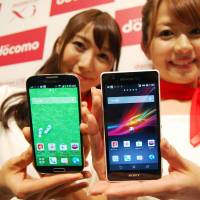 Phone home: Models show off NTT DoCoMo\'s new smartphone handsets in Tokyo\'s Chuo Ward on Wednesday. | KYODO