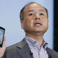 Bank on it: Masayoshi Son, president of Softbank Corp., introduces the company’s Aquos Phone Xx 206SH smartphone during a product launch in Tokyo on May 7. Softbank to sell ¥400 billion in bonds