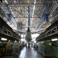 More power: Engineers work to install a redesigned battery into a Boeing Co. 787 Dreamliner owned by All Nippon Airways Co. in a hangar at Haneda airport in Tokyo on April 28. | BLOOMBERG