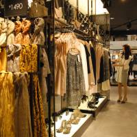 Asian rival arrival: A customer checks out clothes at Mixxo, a South Korean “fast fashion” outlet, at the Sogo department store in Yokohama earlier this month. Mixxo entered the Japanese market in March. 'Fast fashion' of South Korea, Singapore arrives
