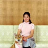Big girl: Princess Aiko, who turned 11 Saturday, poses with her pet dog at Togu Palace, the residence of Crown Prince Akihito and Crown Princess Masako in Tokyo, on Nov. 18. | IMPERIAL HOUSEHOLD AGENCY / AP