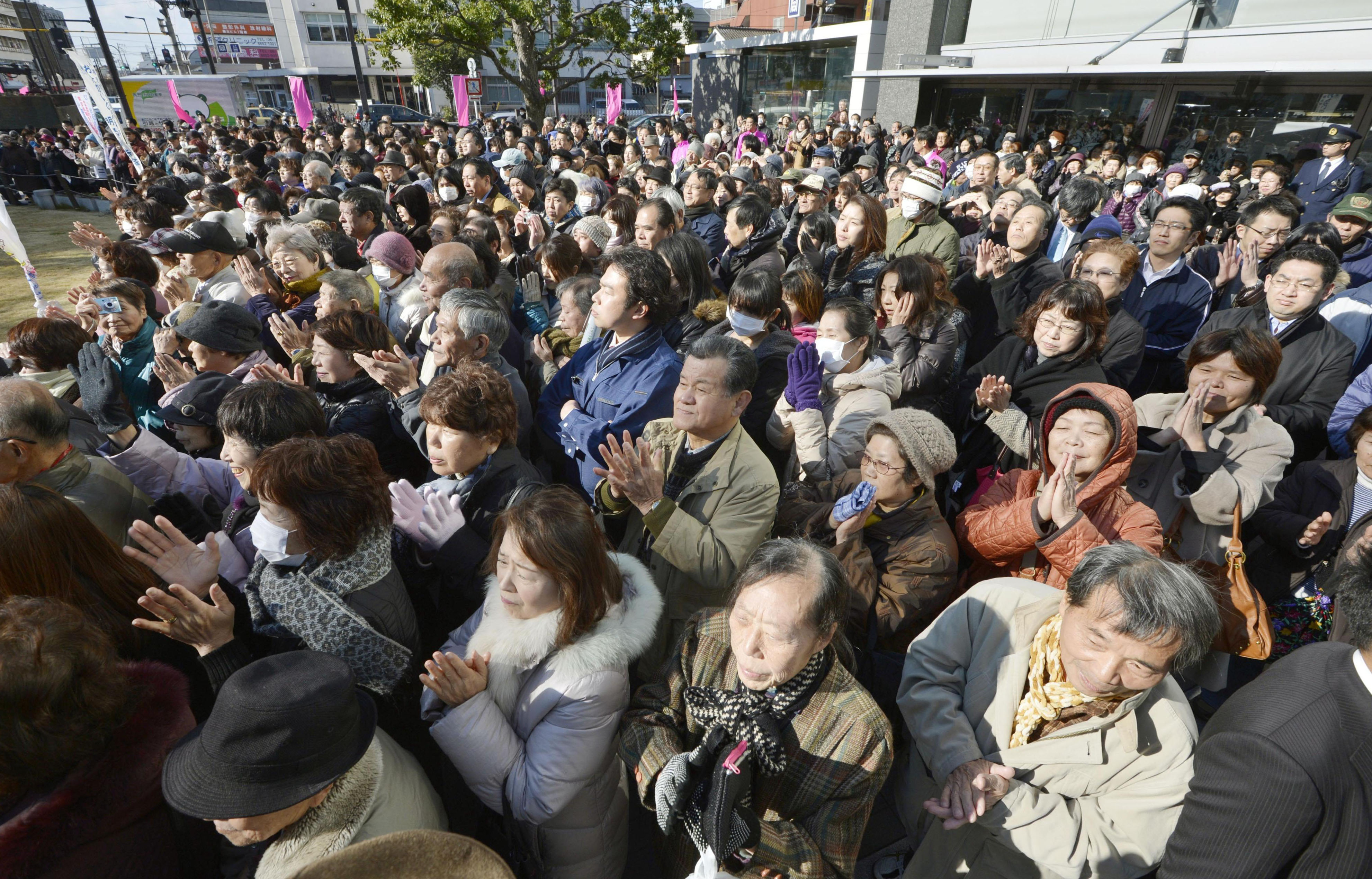 Warmly received: Kansai voters applaud after listening to a candidate running in Sunday's Lower House election give a speech in Nishinari Ward, Osaka, last Thursday. | KYODO