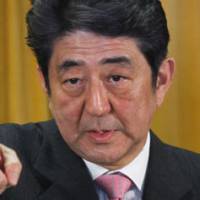 Back in the saddle: Liberal Democratic Party President Shinzo Abe faces reporters Monday at LDP headquarters in Tokyo following the party\'s big win in Sunday\'s general election. | AP