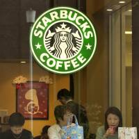 Taking a break: Three women drink coffee at one of Starbucks\' coffee shops in Tokyo. | BLOOMBERG