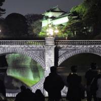 Rare sight: Nijubashi Bridge at the Imperial Palace in central Tokyo is illuminated Sunday night as part of yearend and New Year\'s celebrations. | KYODO