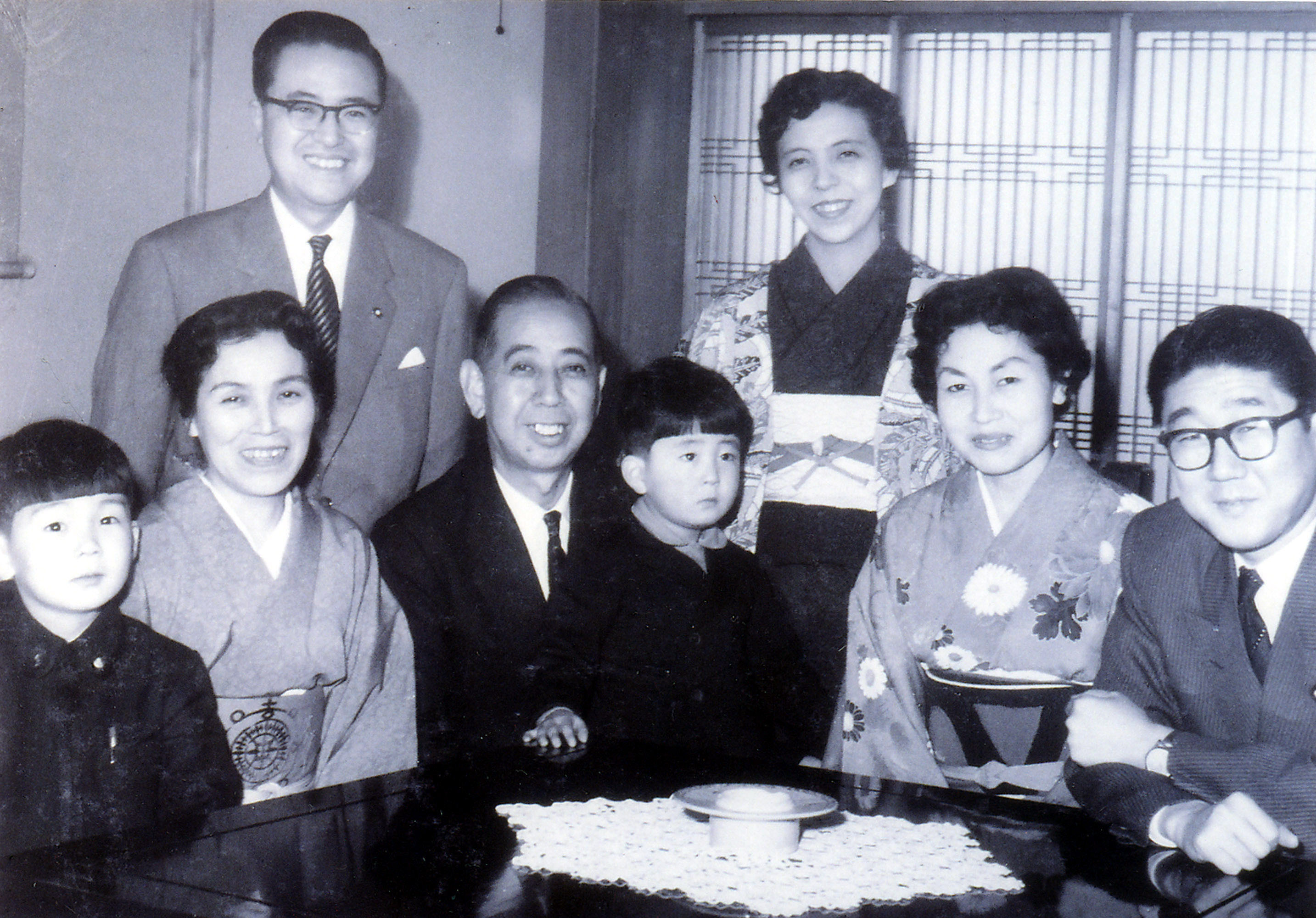 Connected kid: Kindergartner Shinzo Abe sits on the lap of his grandfather, then-Prime Minister Nobusuke Kishi, while his father, Shintaro Abe (right), mother, Yoko (standing), and older brother, Hironobu (left), pose for a family photo. | SHINZO ABE OFFICE / AP