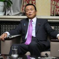 Aso on point: Finance Minister Taro Aso speaks during an interview with media outlets Friday at his ministry in Tokyo. | JUN HONGO