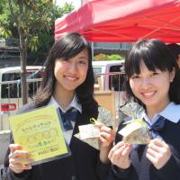 Sweet charity: Mayuko Sako and Saki Nishino of Free The Children Japan sell chocolates at a Tokyo street performance festival in Suginami Ward on Sunday. A portion of the proceeds will be used to help build a school in India. | COURTESY OF FREE THE CHILDREN JAPAN
