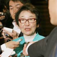 Under fire: Yoriko Kawaguchi, chairwoman of the Upper House Environment Committee, is surrounded by reporters after a meeting with Prime Minister Shinzo Abe in Tokyo on Tuesday night. | NIHON KEIZAI SHIMBUN/KYODO