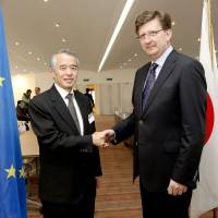 Start: Japan\'s chief negotiator, Jun Yokota (left), shakes hands with his European Union counterpart, Mauro Petriccione, as they launch the first round of free trade agreement negotiations between the EU and Japan, in Brussels on April 15. | EUROPEAN UNION