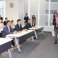 Early learners: Local revitalization expert Hima Furuta conducts a 7:30 a.m. class at Nagoya Morning University in an office building near Nagoya Station last month. |  CHUNICHI SHIMBUN