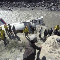 Overshot: Recovery crews and others view the wreckage of a Nepal Airlines Twin Otter that crashed Thursday in the Kaligandaki River in Jomsom, about 200 km northwest of Katmandu. | AP/KYODO