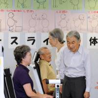 Respect for the aged: Emperor Akihito and Empress Michiko visit a nursing home in Wako, Saitama Prefecture, last September. | KYODO