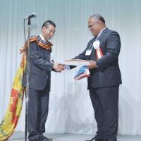 Fiji\'s Ambassador Isikeli Mataitoga (right) presents Honorary Consul General Takeyuki Moriya the Consular Commission during a ceremony held in Sendai on May 17. | EMBASSY OF FIJI