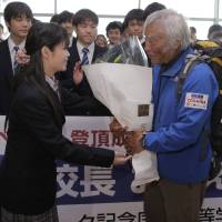 Mountain man: Japanese climber Yuichiro Miura, who became the oldest person to scale Mount Everest, is welcomed by students from Clark Memorial International High School, where he serves as principal, upon his arrival at Tokyo\'s Haneda airport Wednesday. | AP