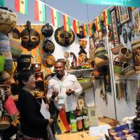 Out of Africa: Visitors view masks, food and baskets at the Ghanaian booth Thursday during African Fair 2013 in Yokohama. | SATOKO KAWASAKI