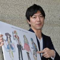 Giving life: Meru Kishida shows off his illustrations of characters representing the World Cosplay Summit during a recent visit to the Chunichi Shimbun\'s offices in Nagoya. | CHUNICHI SHIMBUN