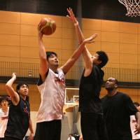 Chosen one: Yuta Watanabe attempts to block a shot from veteran player Kosuke Takeuchi during an intra-squad game at the Japan men\'s national team training camp in Tokyo last Friday. | KAZ NAGATSUKA