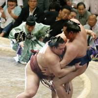Never a dull moment: Ozeki Kisenosato sends Karuryu out of the raised ring with a loss at the Summer Grand Sum Tournament on Friday. | KYODO