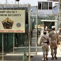 Indefinite detention: Military guards are seen walking at Camp Delta military prison at the U.S. naval base in Guantanamo Bay, Cuba, in 2006. | AP