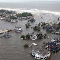 Come high water: This U.S. Air Force photo shows flooding from Superstorm Sandy in Mantoloking, New Jersey, last October. | AP