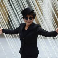 Starting over: Artist Yoko Ono poses in front of one of her works at her exhibition in Frankfurt, Germany, in February. Now 80, she says she feels like she is just beginning \"a second life that will have so many things i didn\'t have in the first life.\" | AP