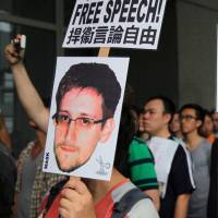 Hong Kong help: Supporters of Edward Snowden gather outside the Hong Kong government building Saturday. | BLOOMBERG