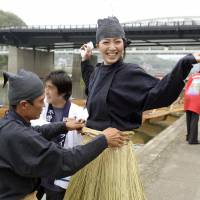 Kotomi Inayama, 24, prepares for her first day of fishing with cormorants Saturday along the Kiso River in Inuyama, Aichi Prefecture. Traditionally, only men have used the diving bird to fish but a handful of women have taken up the practice in recent years. Inayama is the sixth in the nation and the first in the Tokai region to do so. | KYODO