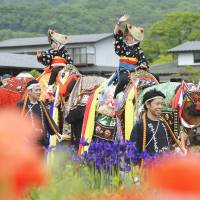 Young girls take part in the traditional Chagu Chagu Umakko festival in the village of Takizawa, Iwate Prefecture, on Saturday. The event is said to have originated during the Edo Period, when farmers decorated working horses to wish for good health. | KYODO