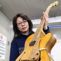 Live forever: When a 300-year-old elm tree, which was a symbol of the town of Shimokawa in Hokkaido, was destroyed, the citizens asked a guitar-maker to construct this beauty out of its remains. | KYODO PHOTO