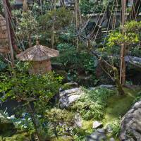 Straw wrappings protect the Nomura Samurai House garden\'s stone lanterns from freezing winter weather. | STEPHEN MANSFIELD PHOTO